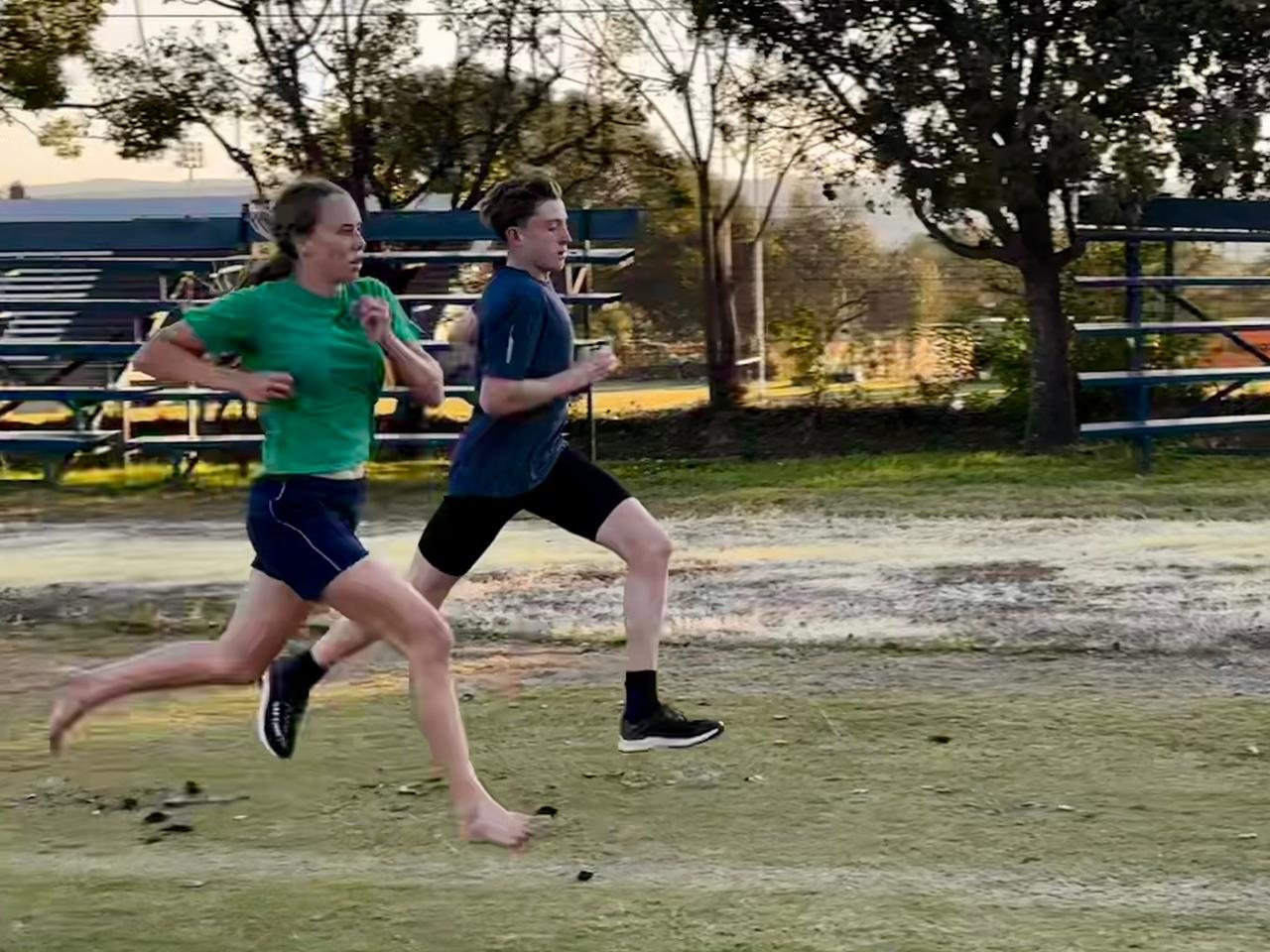 Two athletes running during a training session